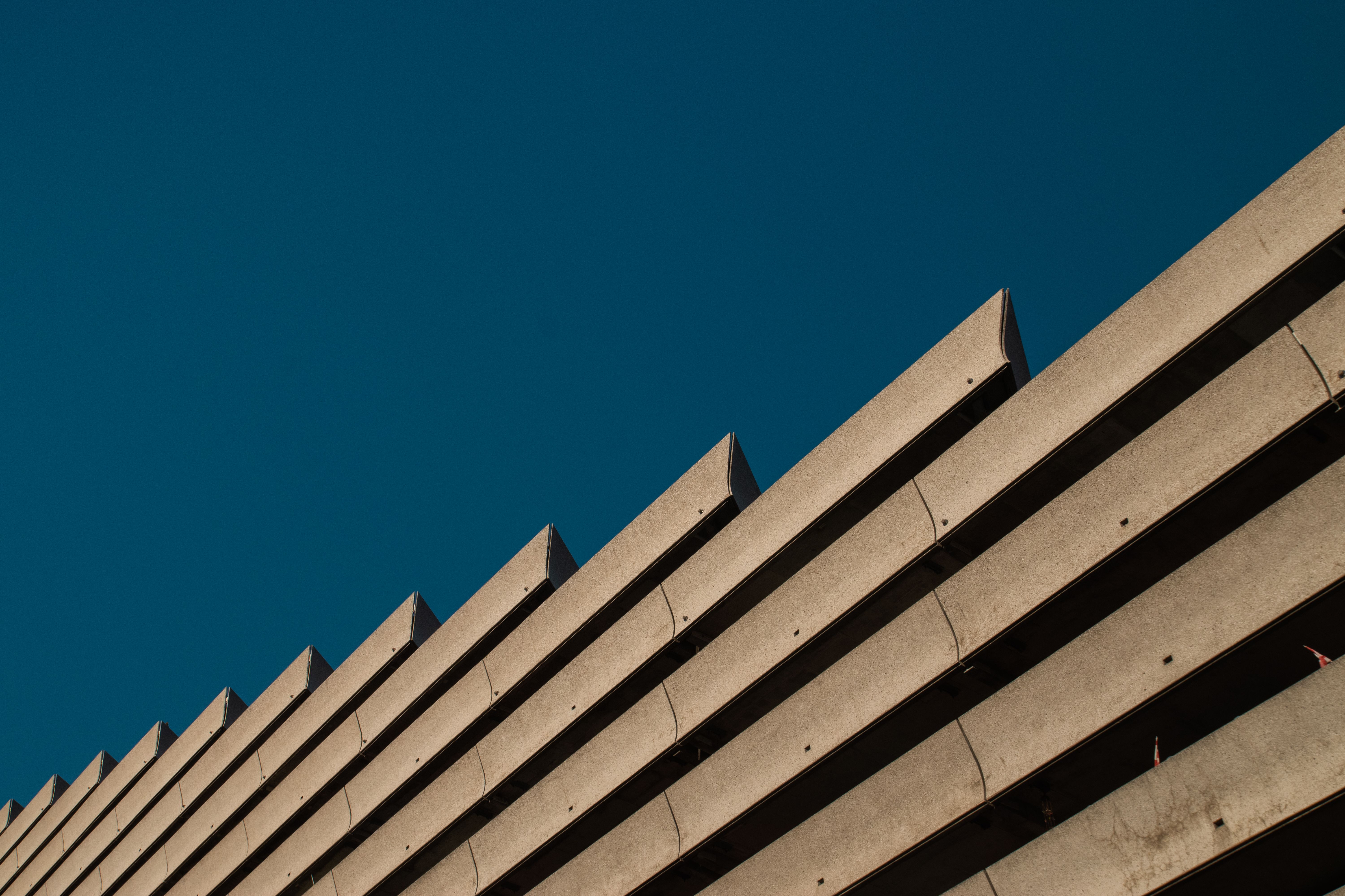 Low angle shot of modern building against clear blue sky showcasing minimalist architecture