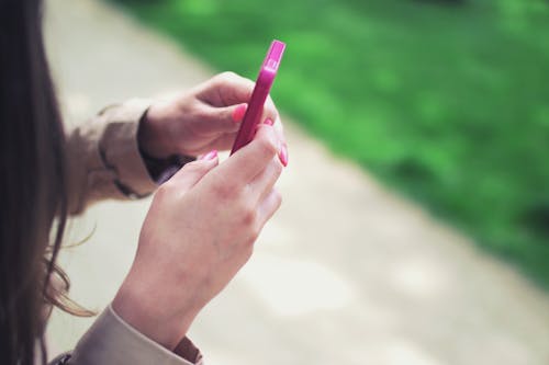 Person Holding Pink Mobile Phone