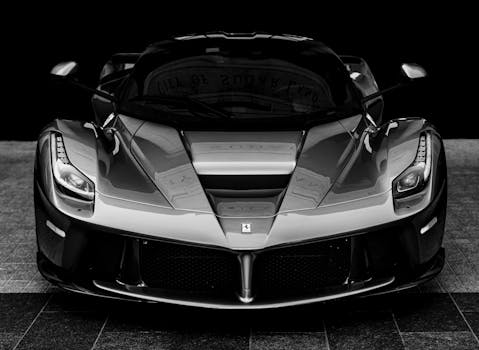 Monochrome close-up of a luxury sports car showcasing design and power.