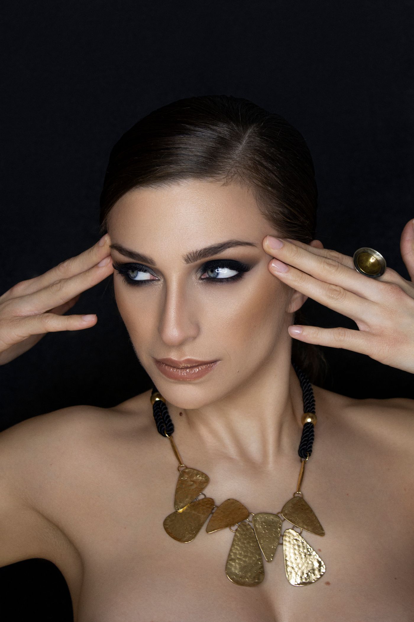 Portrait with a sculptural gold necklace