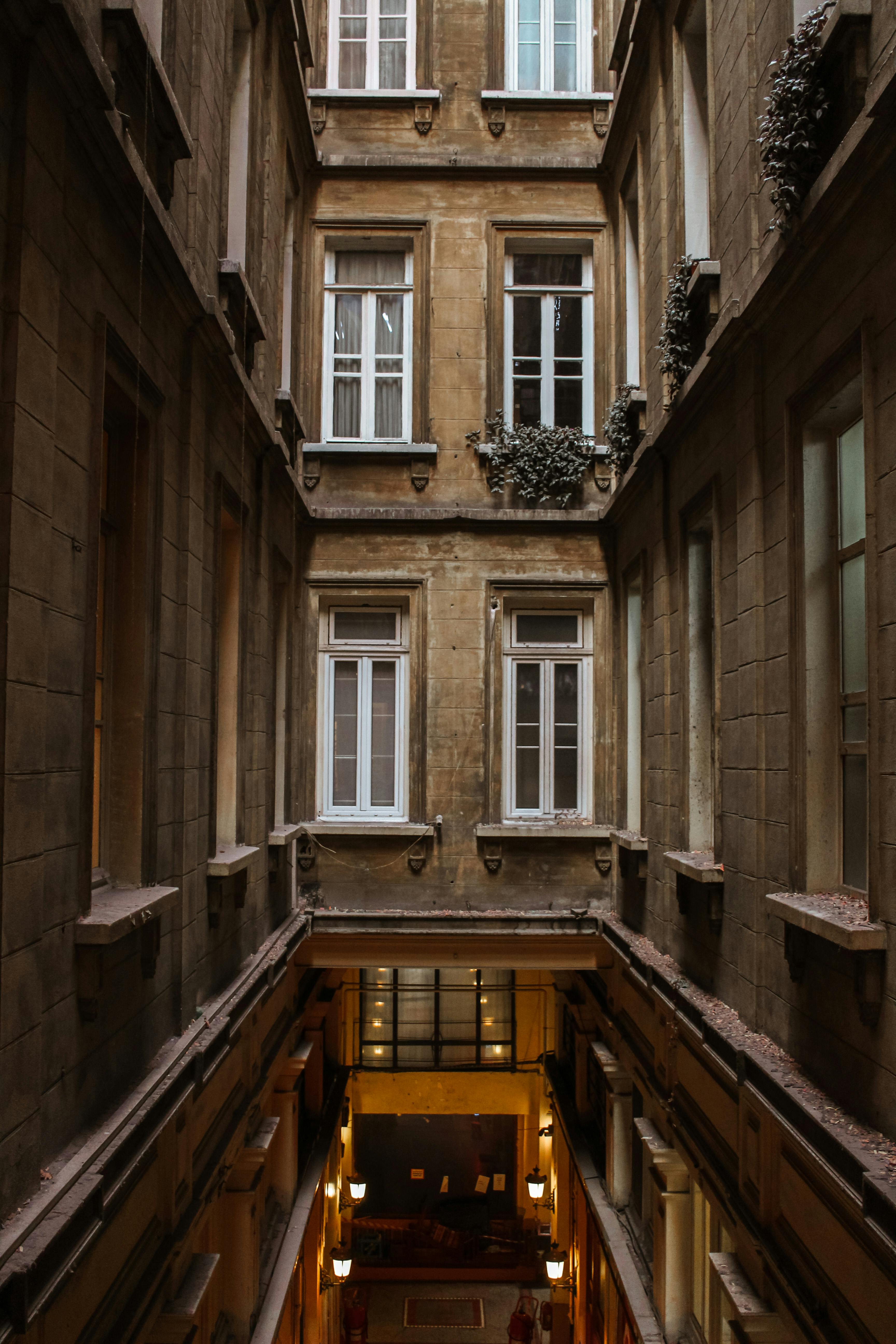 A vertical shot of a vintage building atrium showcasing elegant architectural details.