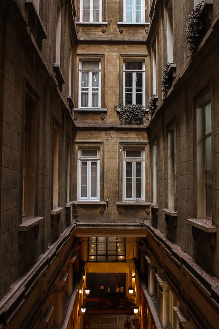 A vertical shot of a vintage building atrium showcasing elegant architectural details.