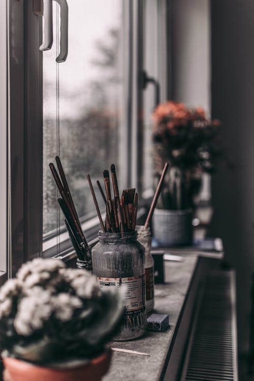 Paintbrushes and Holders on the Window Sill