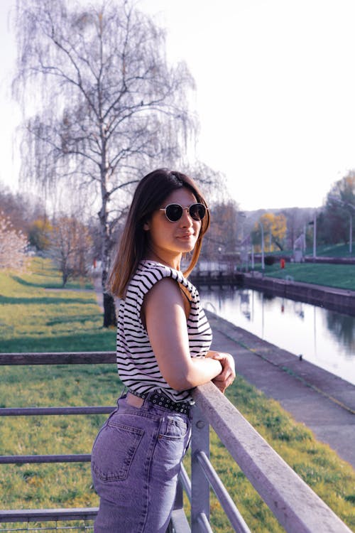 A Woman in Striped Shirt Wearing Sunglasses
