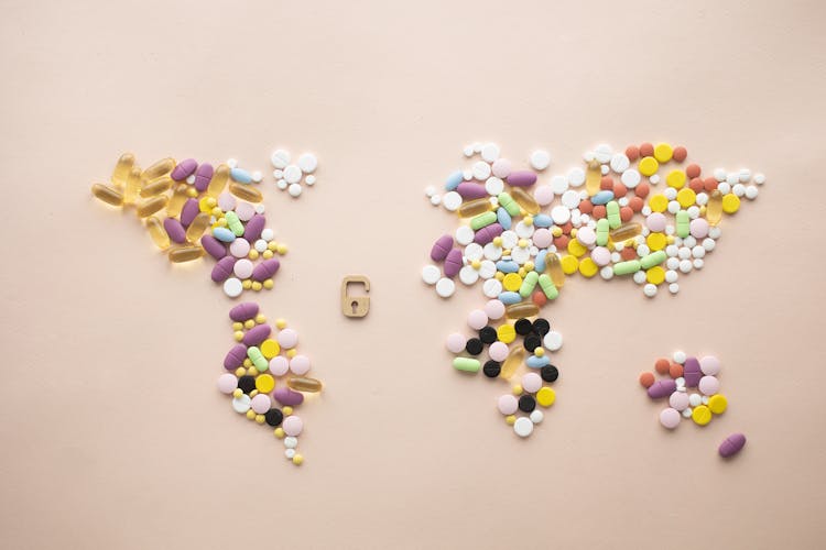 World Map Made Of Tablets And Capsules And Little Lock