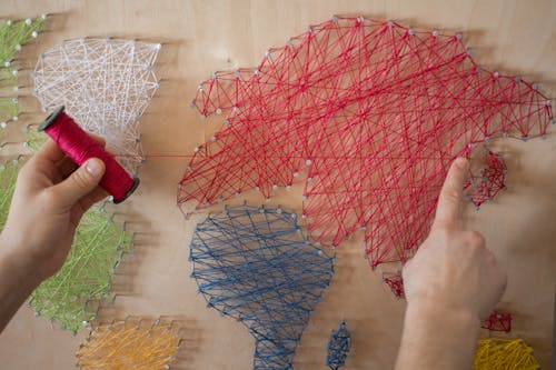 A Person Making a String Art