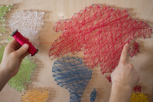 A Person Making a String Art
