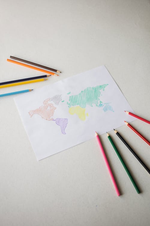 Picture of world map and set of colorful pencils