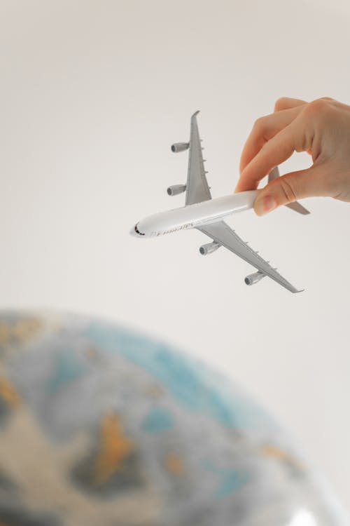 Free Close-Up Shot of a Person Holding an Airplane Toy Stock Photo