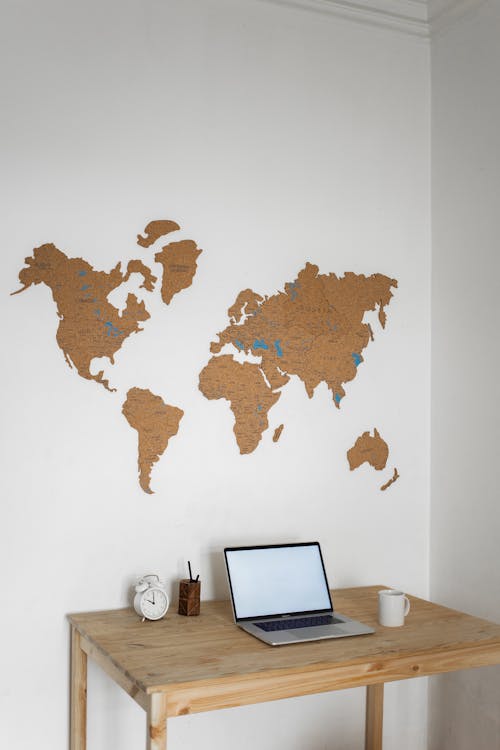 Free Laptop near decorative world continents Stock Photo