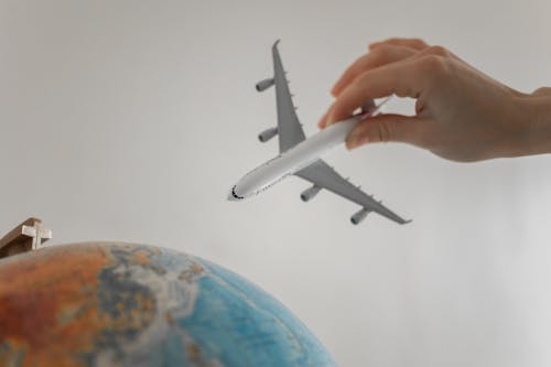 Close-Up Shot of a Person Holding an Airplane Toy