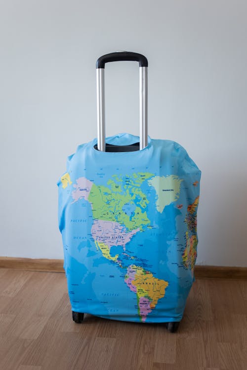 Suitcase with world map in room