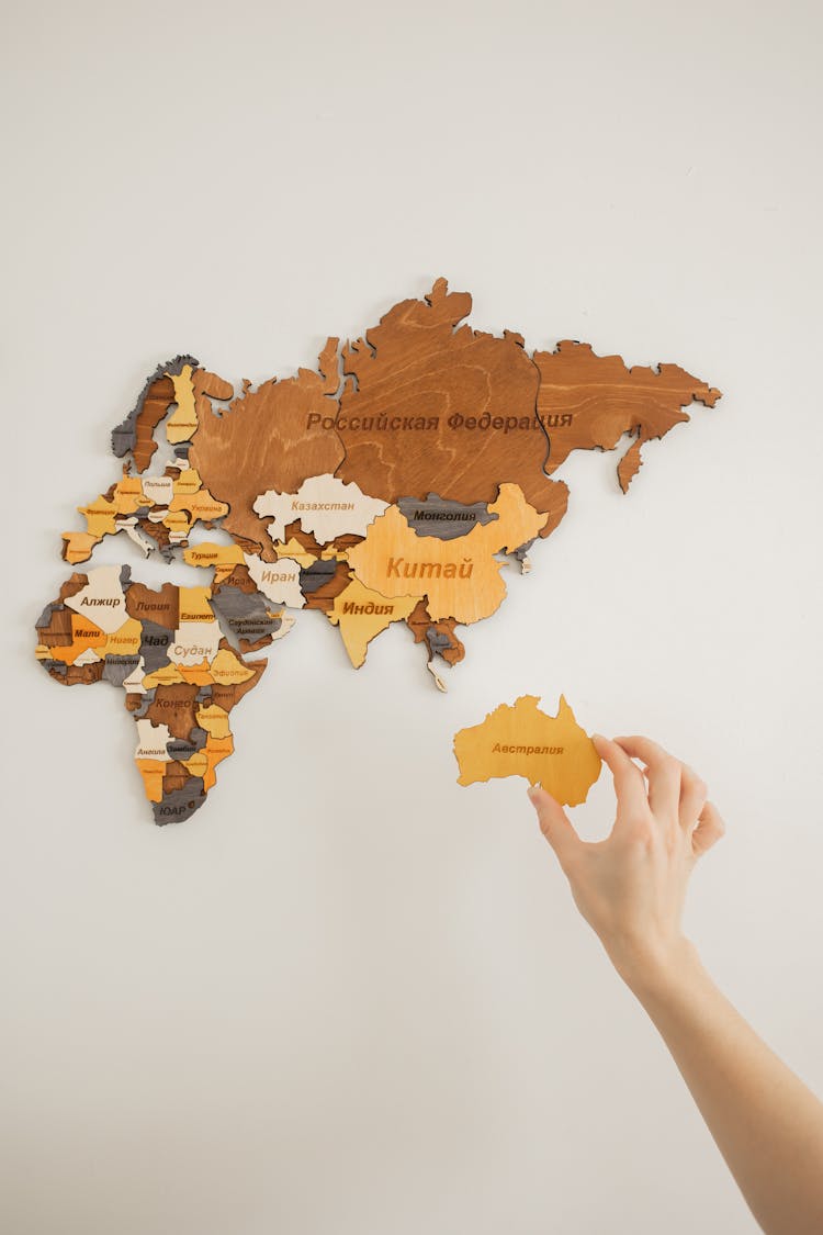 Unrecognizable Traveler Making World Map