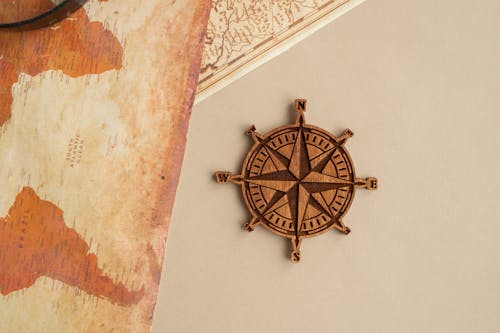 Free Wind rose with maps on table Stock Photo