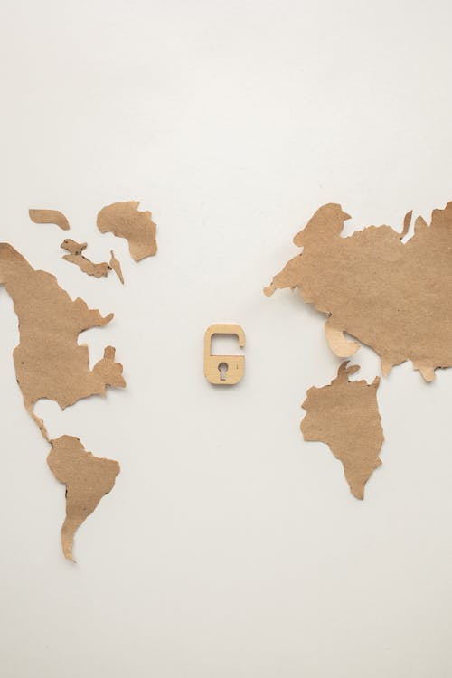 Creative brown empty world map with continents and decorative wooden lock attached on clean white background in modern light studio
