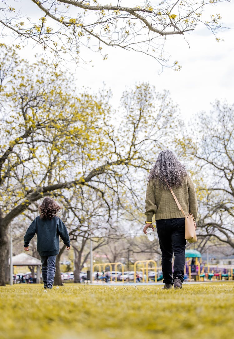 Unrecognizable Grandmother With Grandchild Spending Time In Urban Park