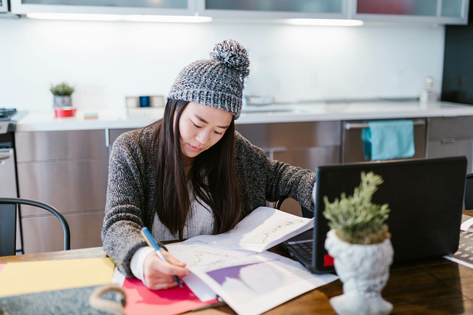 Woman in Hat Working with Statistical Data at Home Office