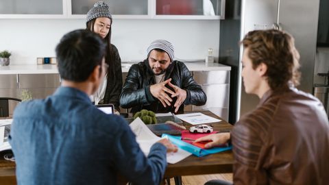A group of diverse colleagues in a modern office setting engaged in a brainstorming session.