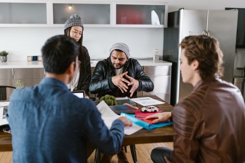 Free A group of diverse colleagues in a modern office setting engaged in a brainstorming session. Stock Photo
