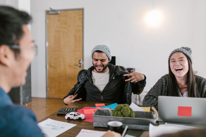 Creative group cracking up around a worktable — RDNE Stock project on Pexels