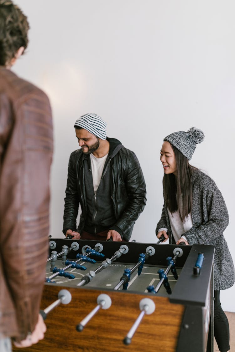 Man And Woman Playing Foosball