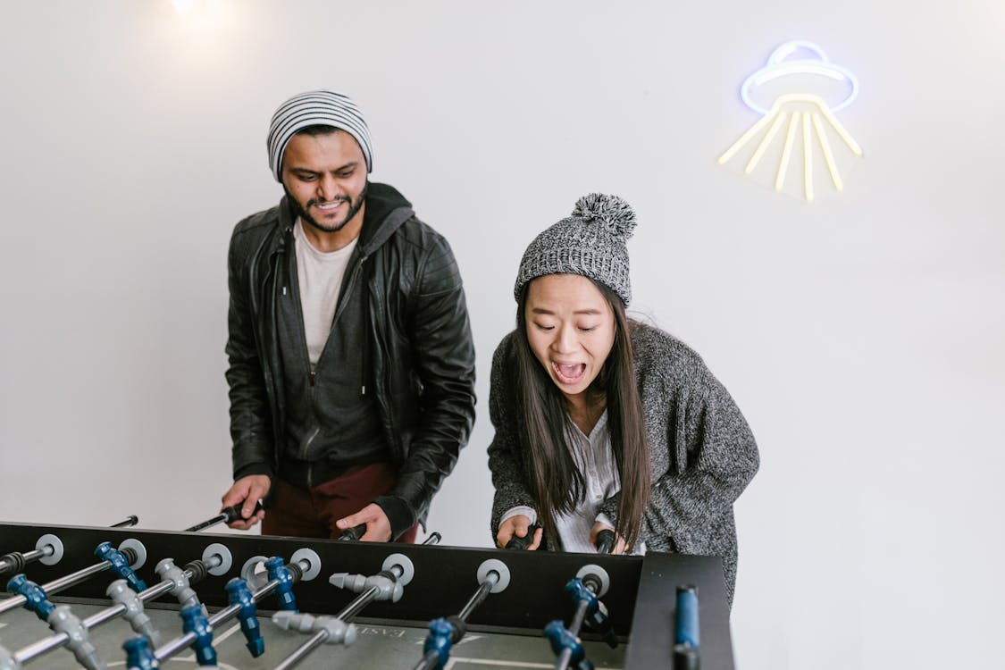 Free A Man and Woman Playing Foosball Stock Photo