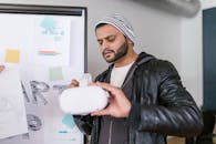 A Man Holding a VR Glasses