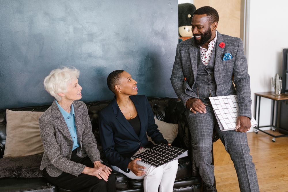 Three business people smiling in a meeting