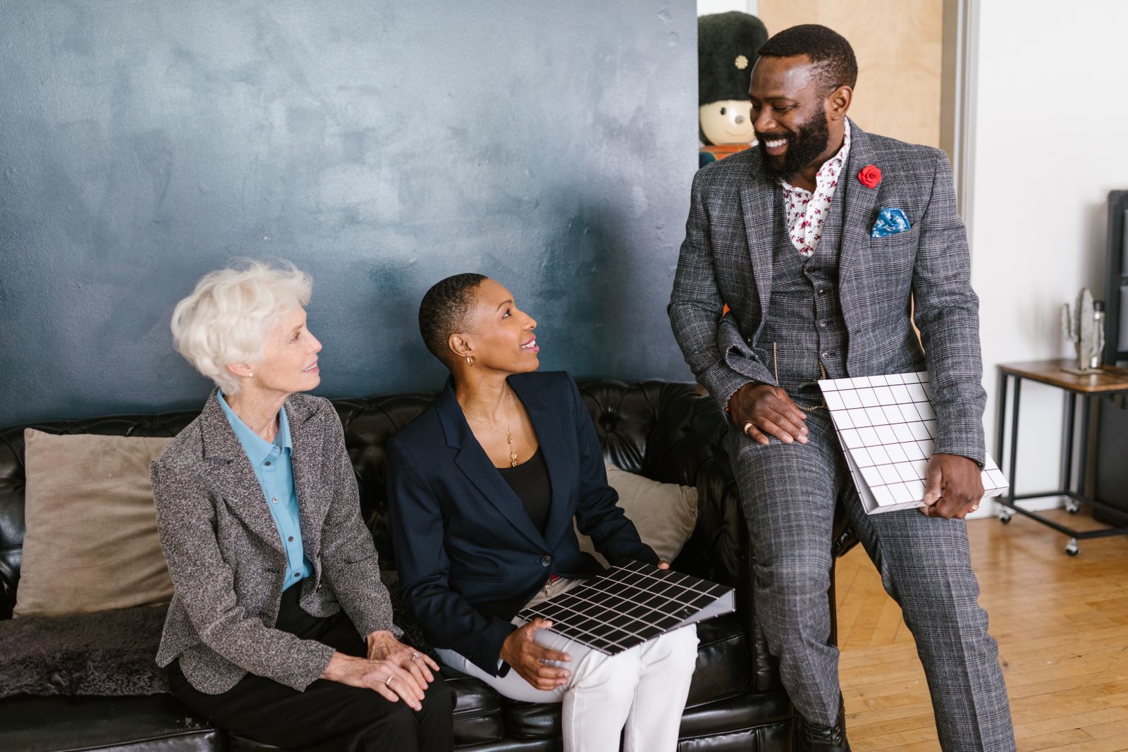 Three business people smiling in a meeting