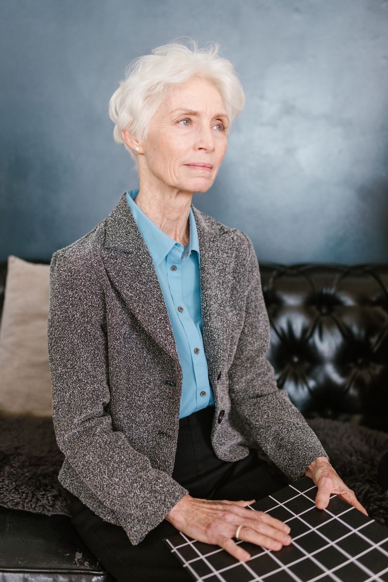 elegant mature woman in classic tweed jacket and black trousers