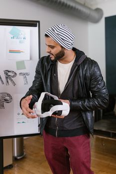 Man with VR headset presenting in a startup office setting, embodying technology and innovation.