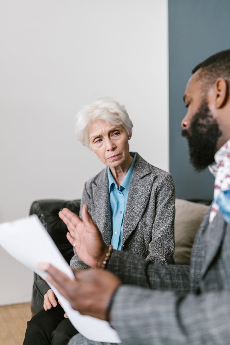 An Investor Listening To A Bearded Man