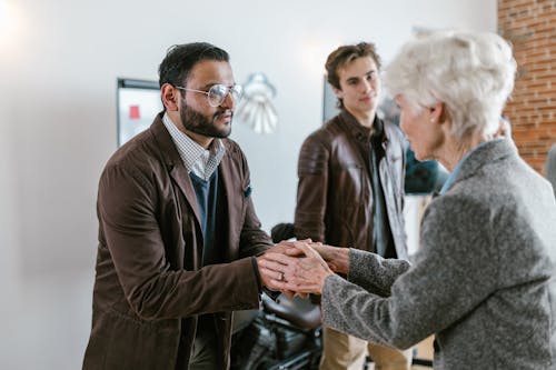 Free A Man Greeting an Elderly Woman Stock Photo