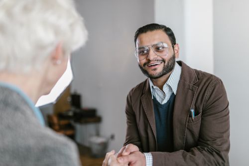 Free Two business professionals engaged in a friendly handshake indoors. Stock Photo