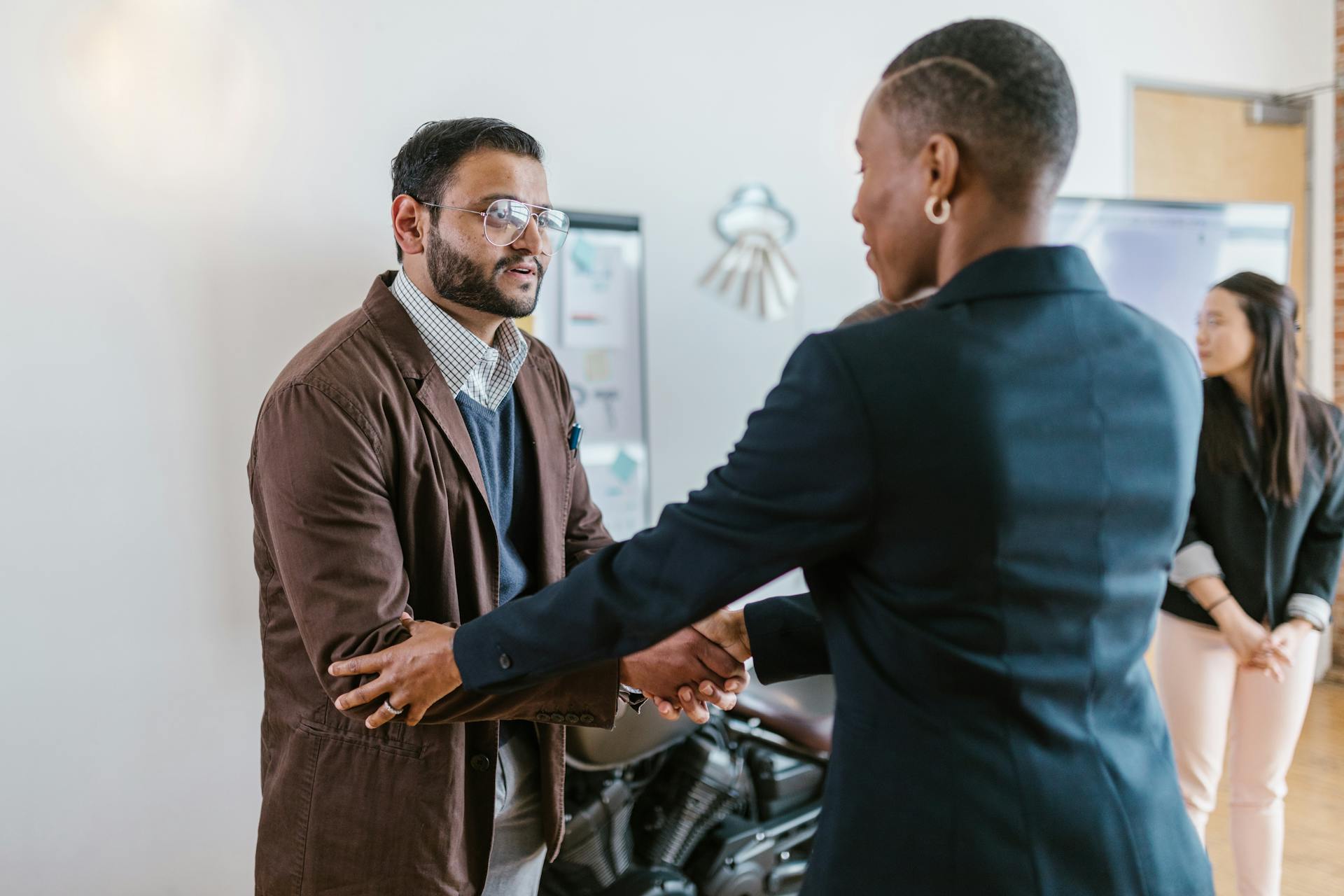 A Man and a Woman Shaking Hands Doing Business