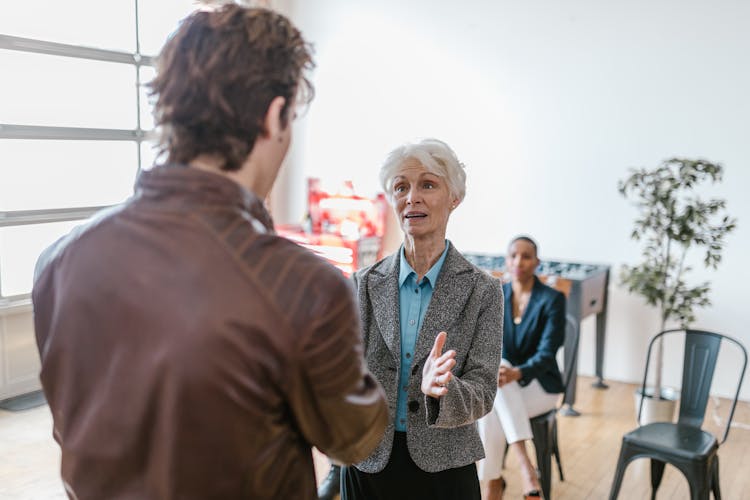 An Elderly Woman In A Business Meeting