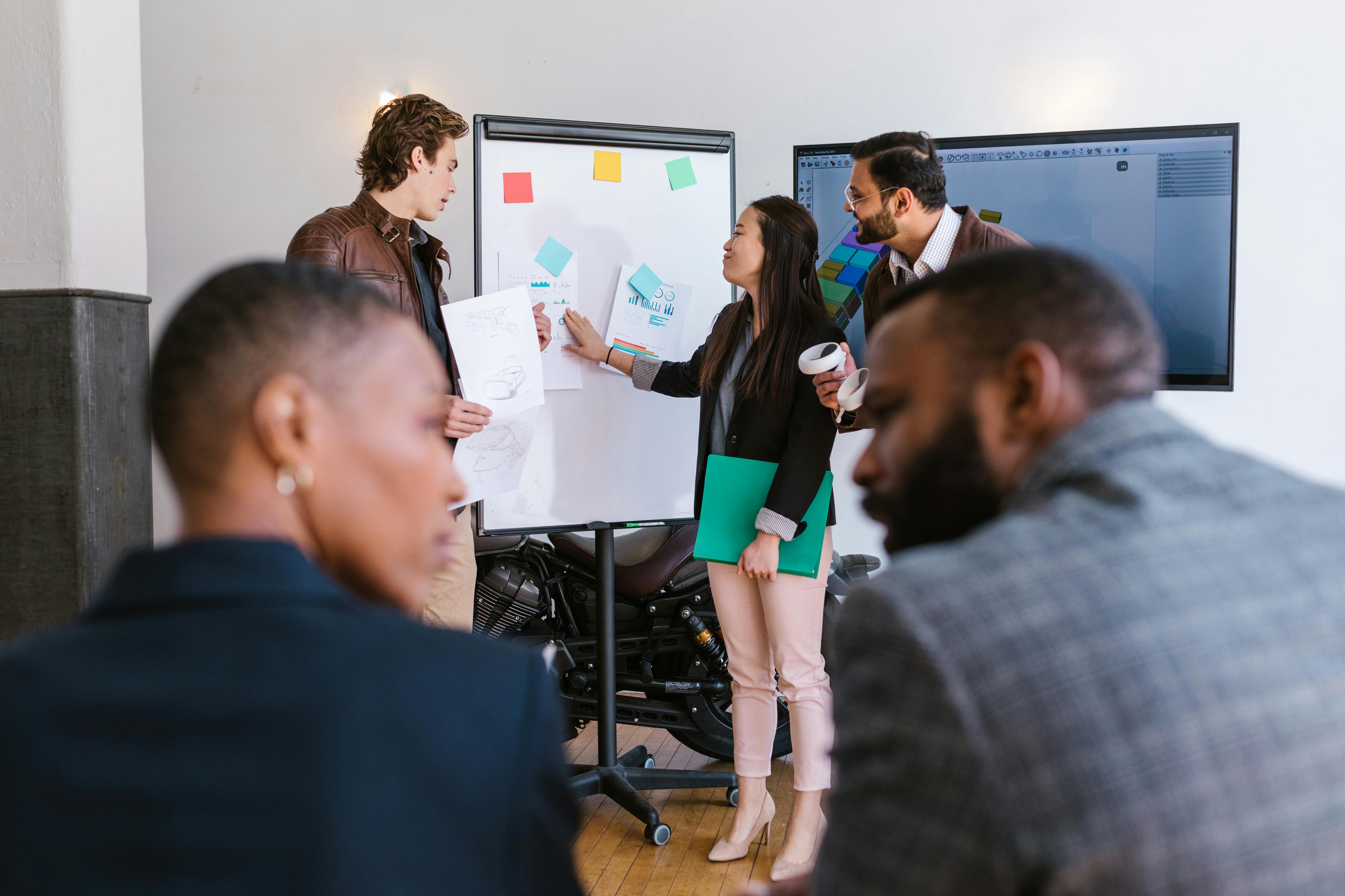 A diverse group of business professionals collaborating during a startup meeting, highlighting teamwork and innovation.