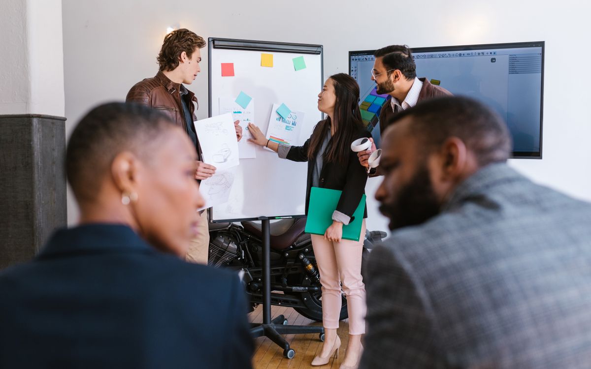 A diverse group of business professionals collaborating during a startup meeting, highlighting teamwork and innovation.