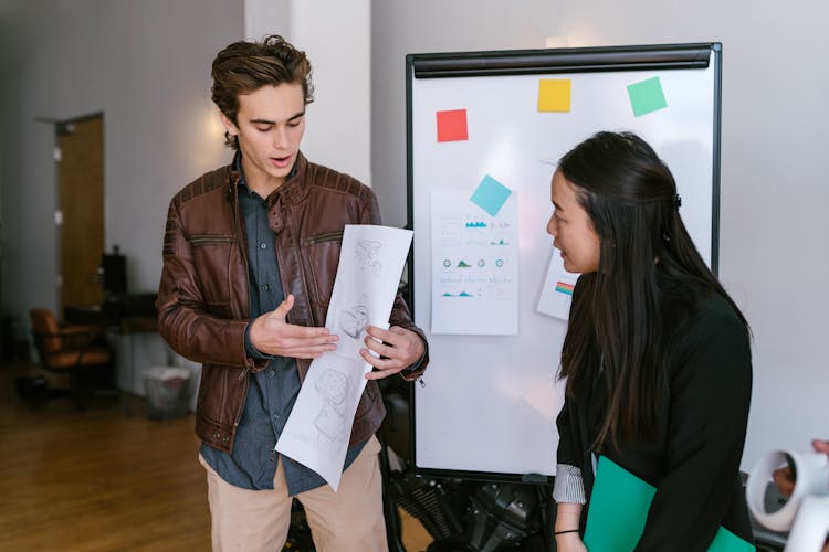 A Man And A Woman Making A Business Presentation