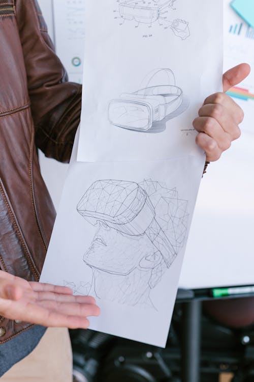 Person Holding Papers with Drawing