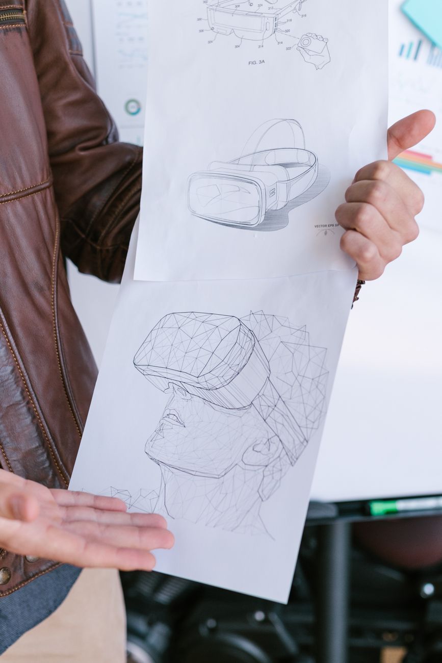 Maya Hart reviewing interface sketches at a desk