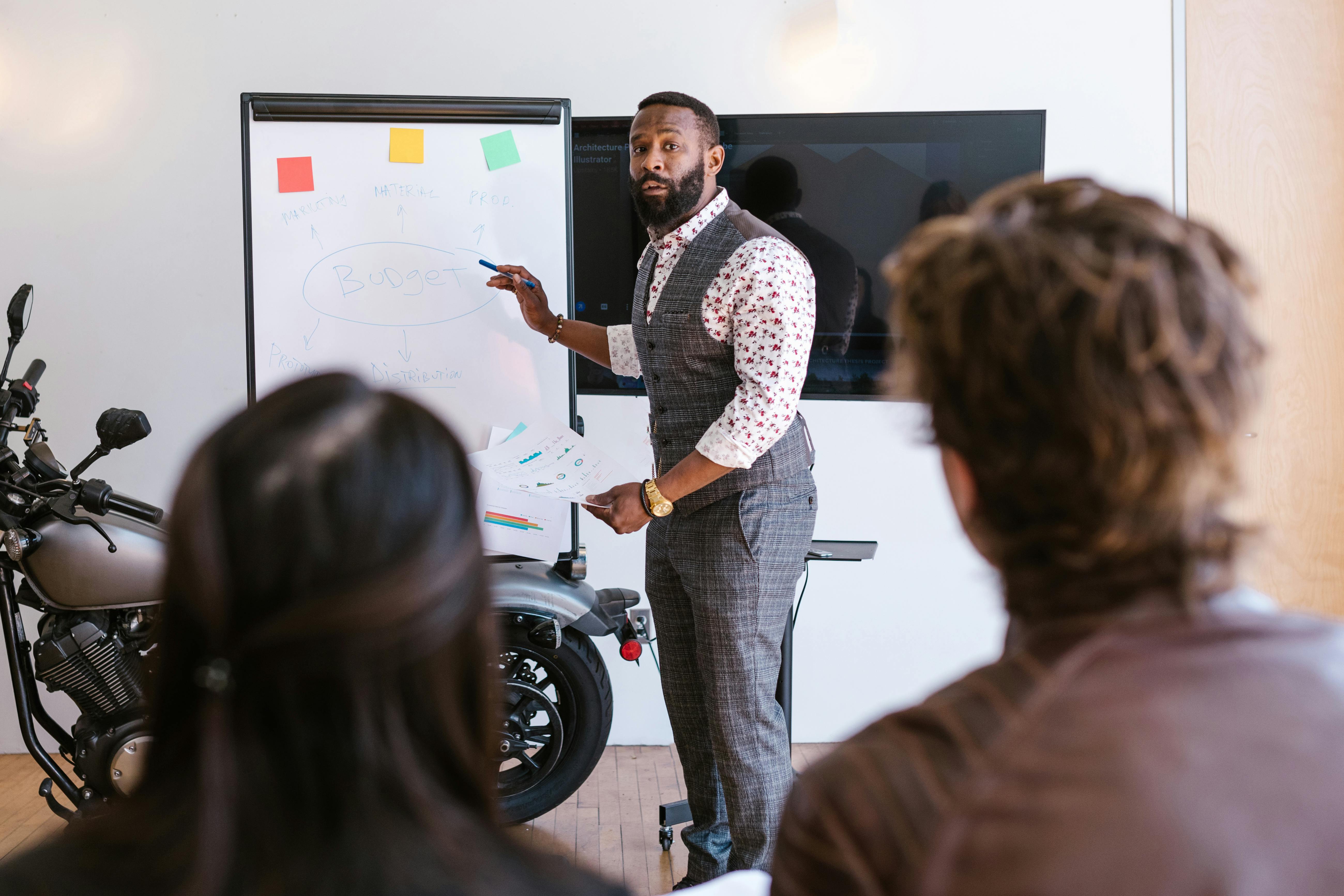 bearded man presenting in front of people