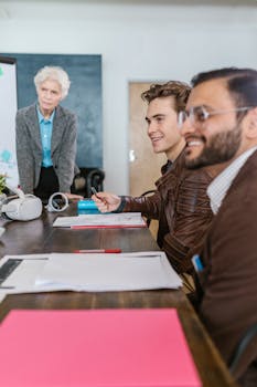 Professional business team engaged in a strategic meeting, analyzing documents and collaborating actively.