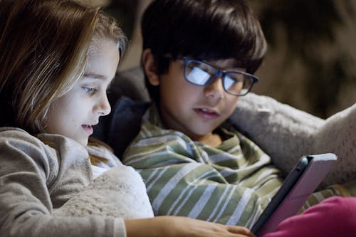 Free Kids Watching Video on a Tablet Stock Photo