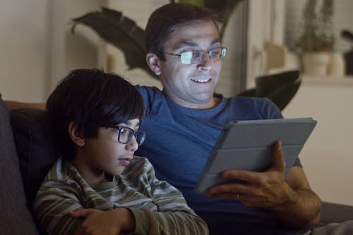 Free Father and Son Watching Video Stock Photo