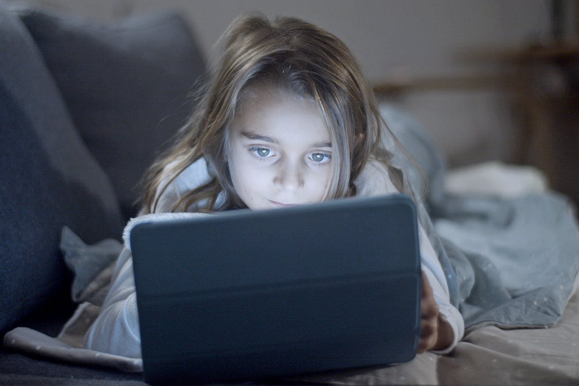Girl in White Shirt Holding Blue Tablet Computer