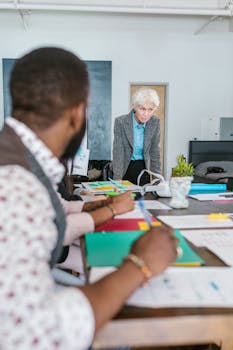 Diverse group of entrepreneurs brainstorming in a modern office setting.