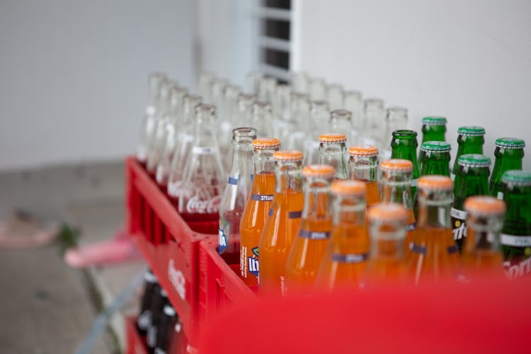 Close-Up Shot Of Bottles Of Soft Drinks On A Crate