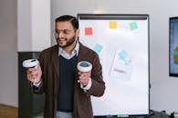 A Bearded Man Holding Virtual Reality Controllers