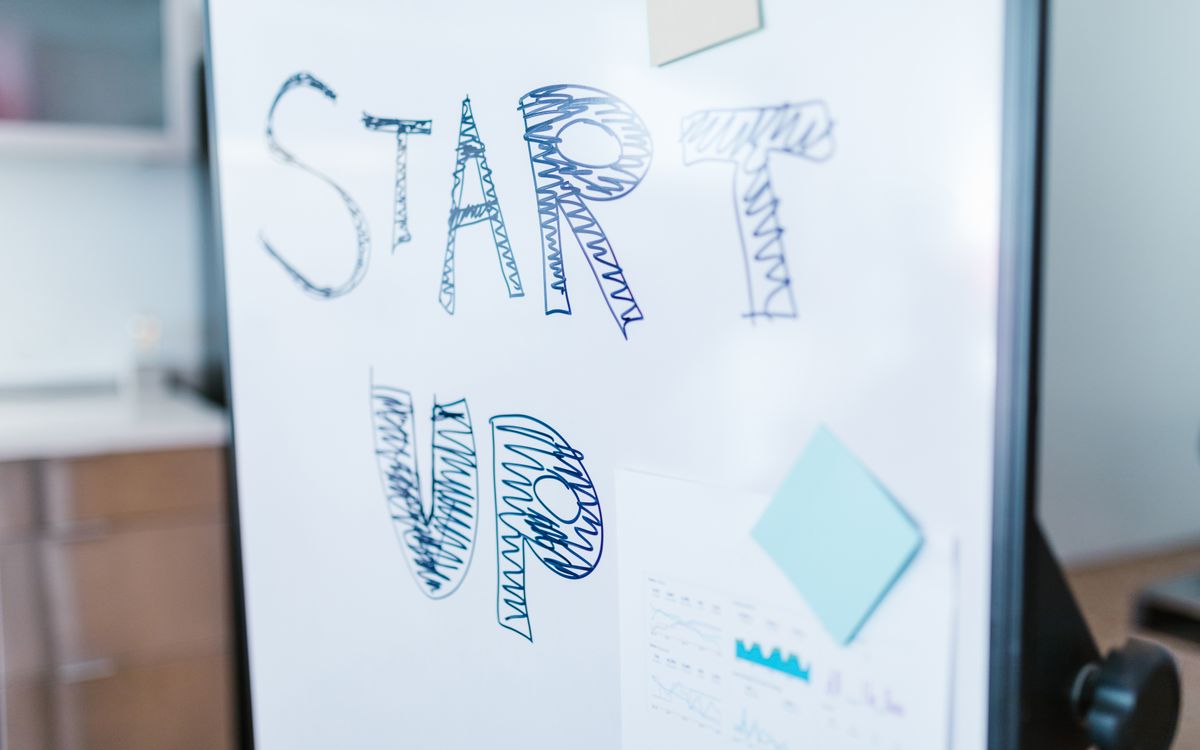 Creative startup concept handwritten on a whiteboard, symbolizing innovation in business.